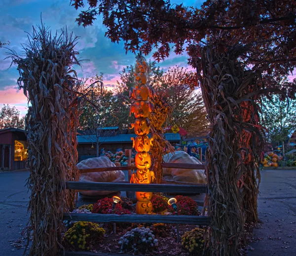 Decorative pumpkin totem pole with carved jack o lantern faces